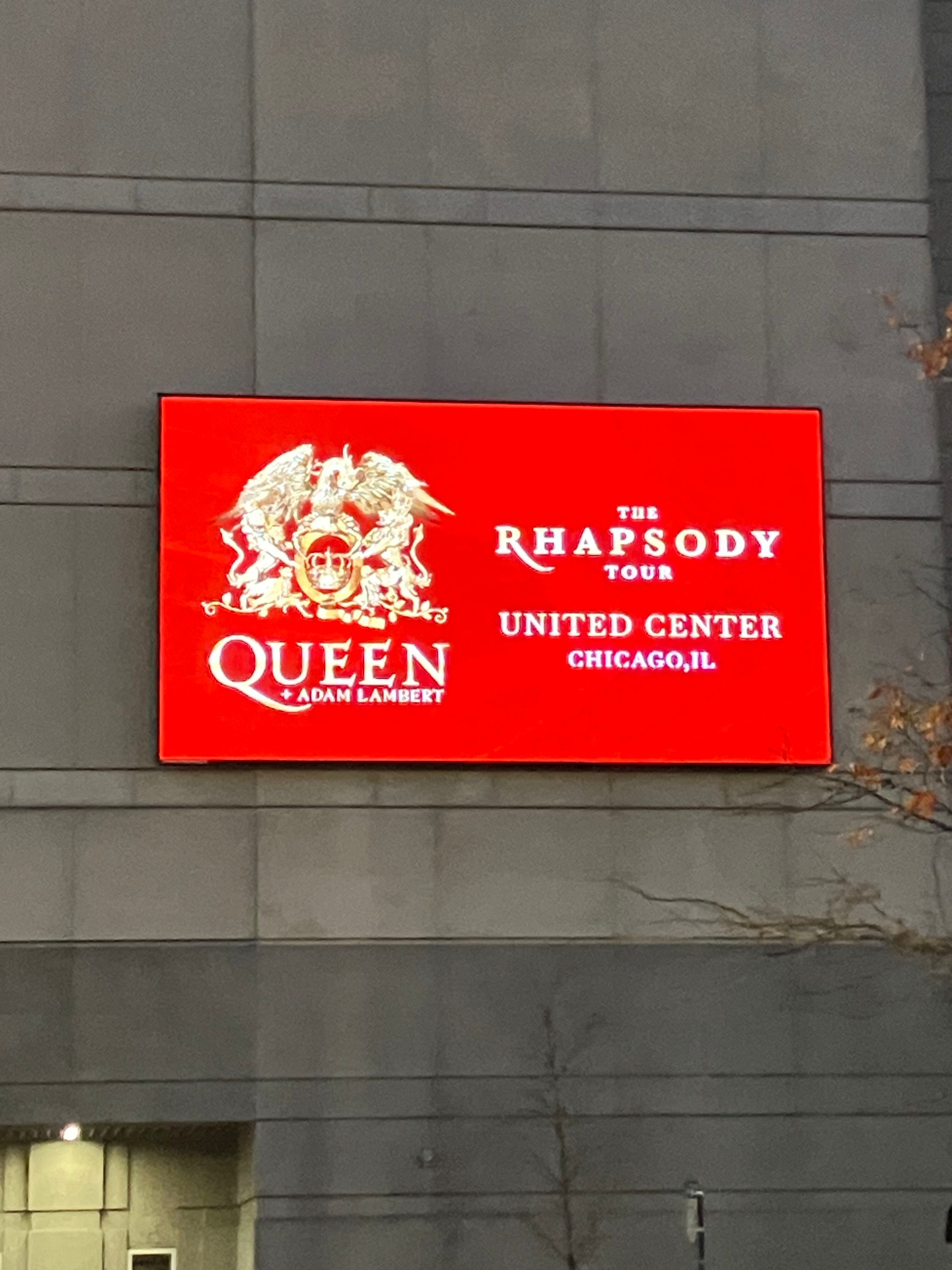 Red sign for Queen + Adam Lambert, The Rhapsody Tour, on the United Center wall