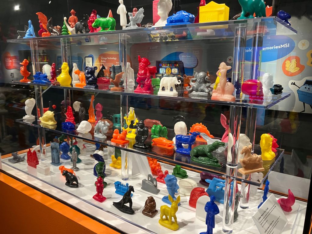 Display case filled with colorful Mold-A-Rama wax figures