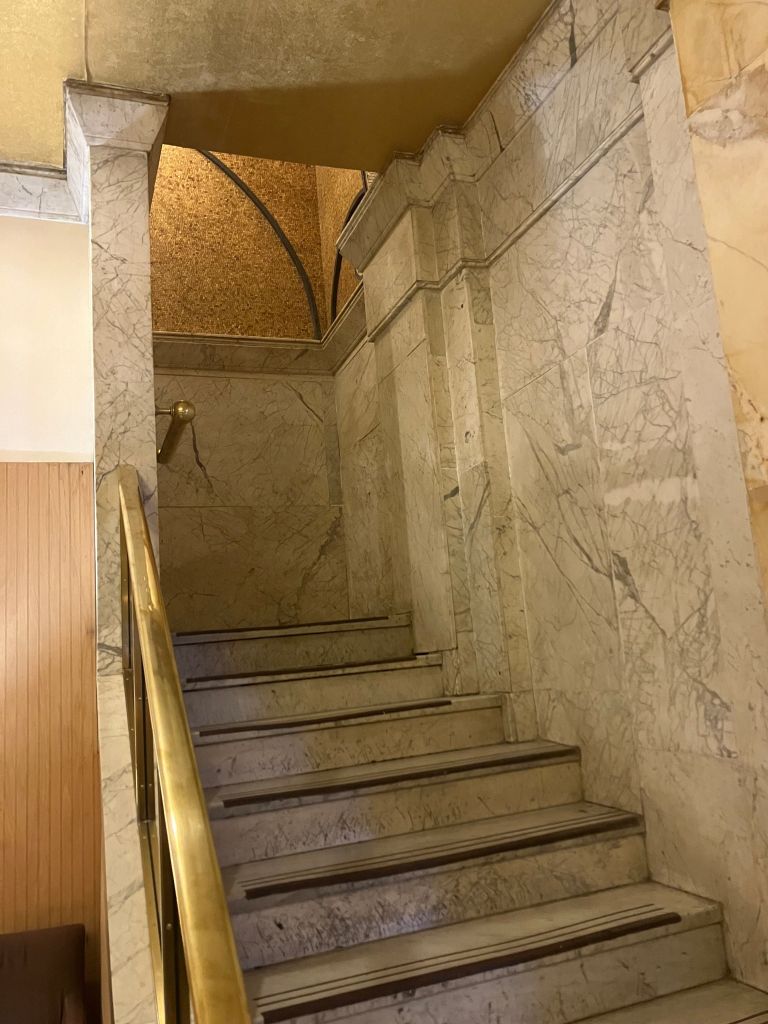 Marble staircase with a brass handrail in the hotel