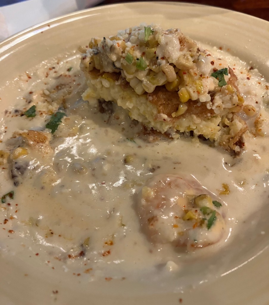 Close view of the dish topped with corn in a creamy sauce