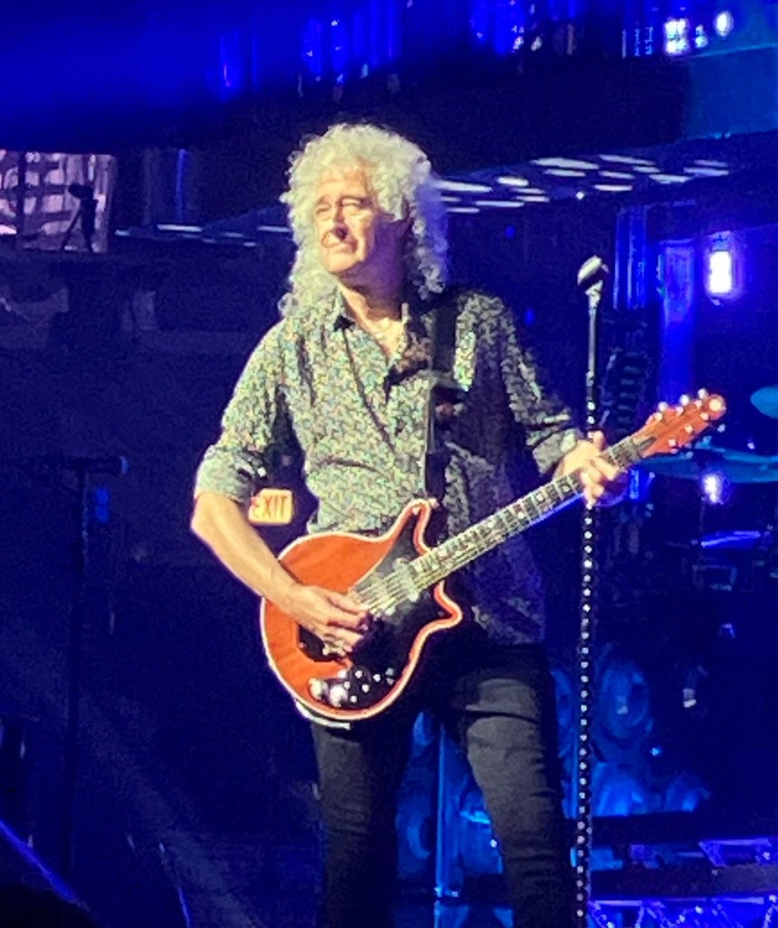 Brian May playing guitar on stage at the United Center