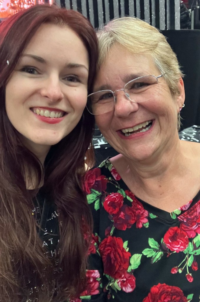 Suzy and Lisa smiling in a selfie at the Queen + Adam Lambert concert