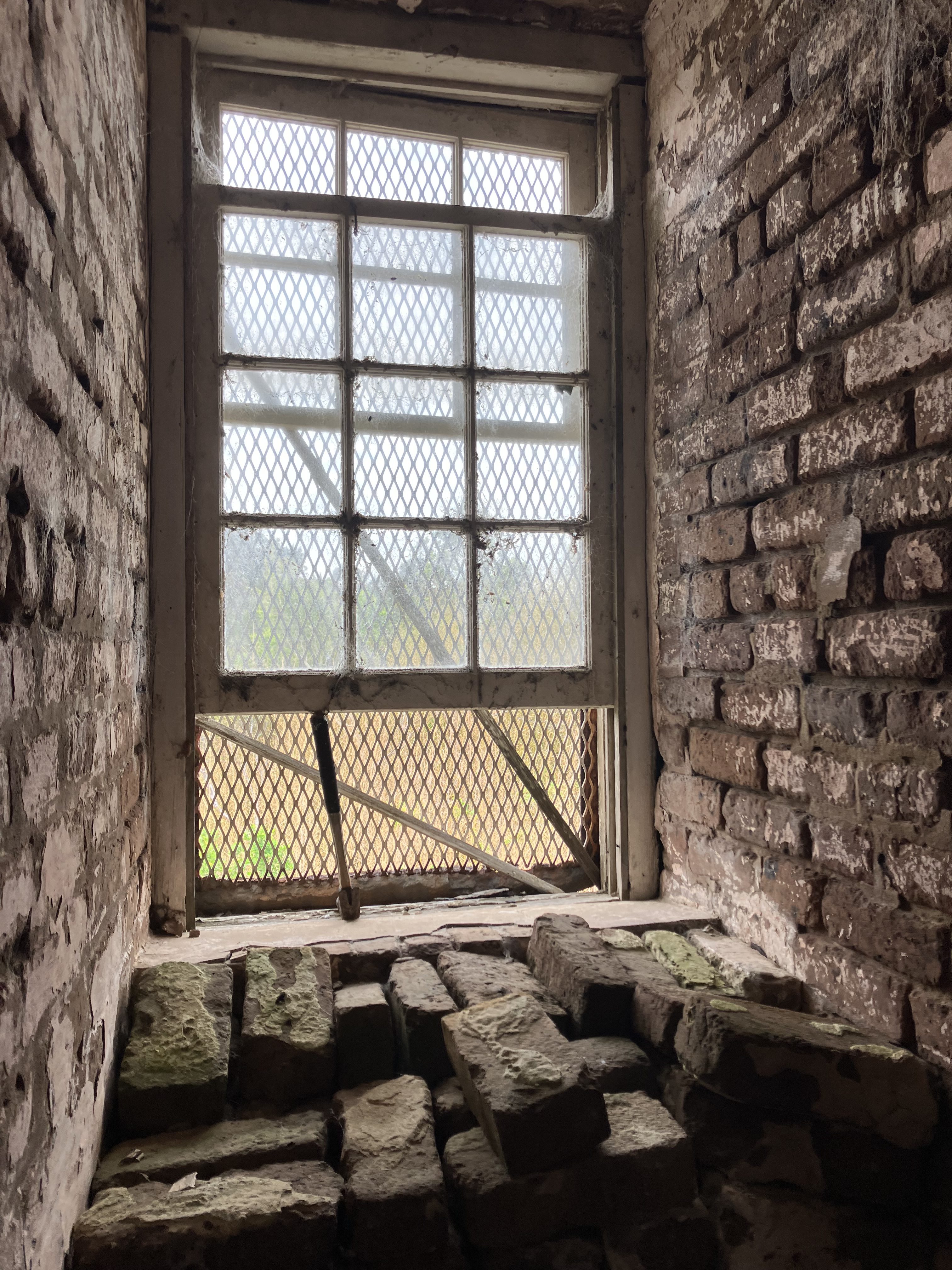 Window in the thick brick wall inside the lighthouse