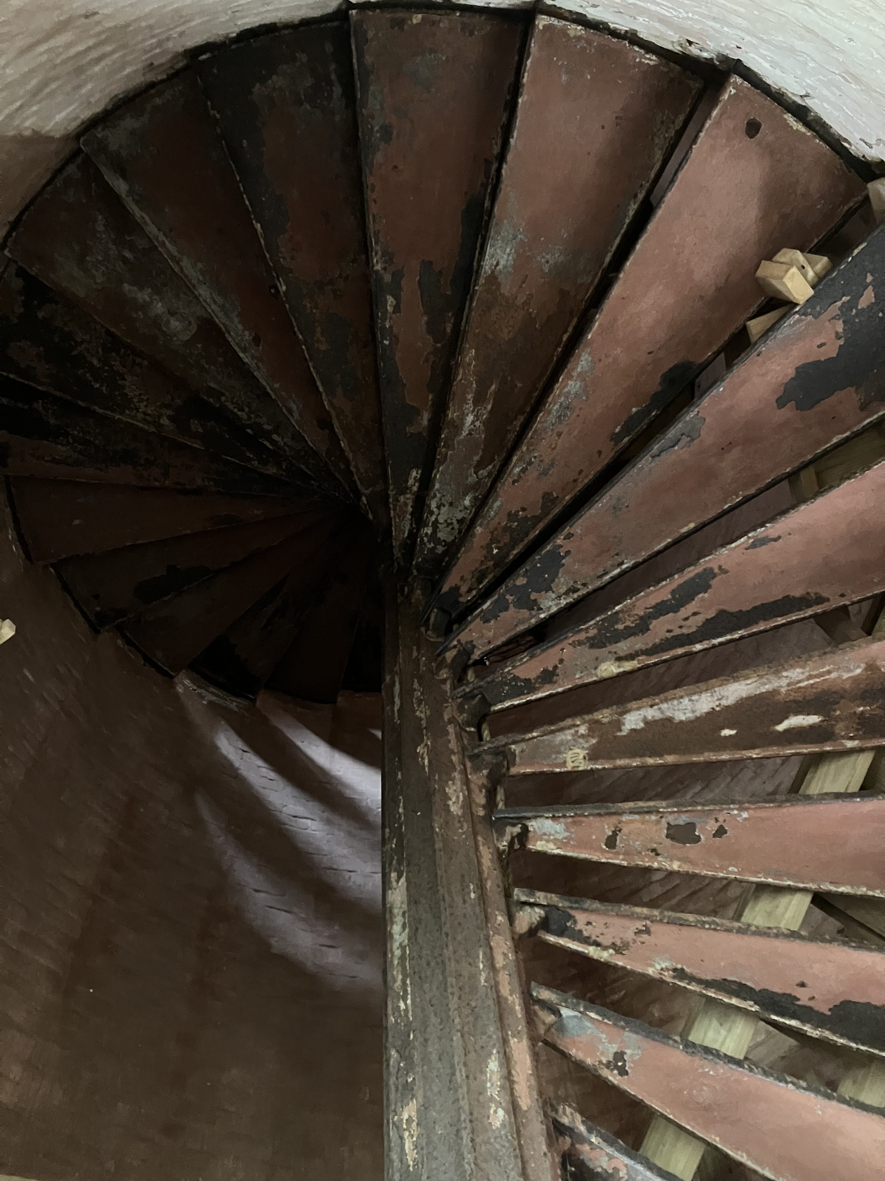 Iron spiral staircase curving overhead