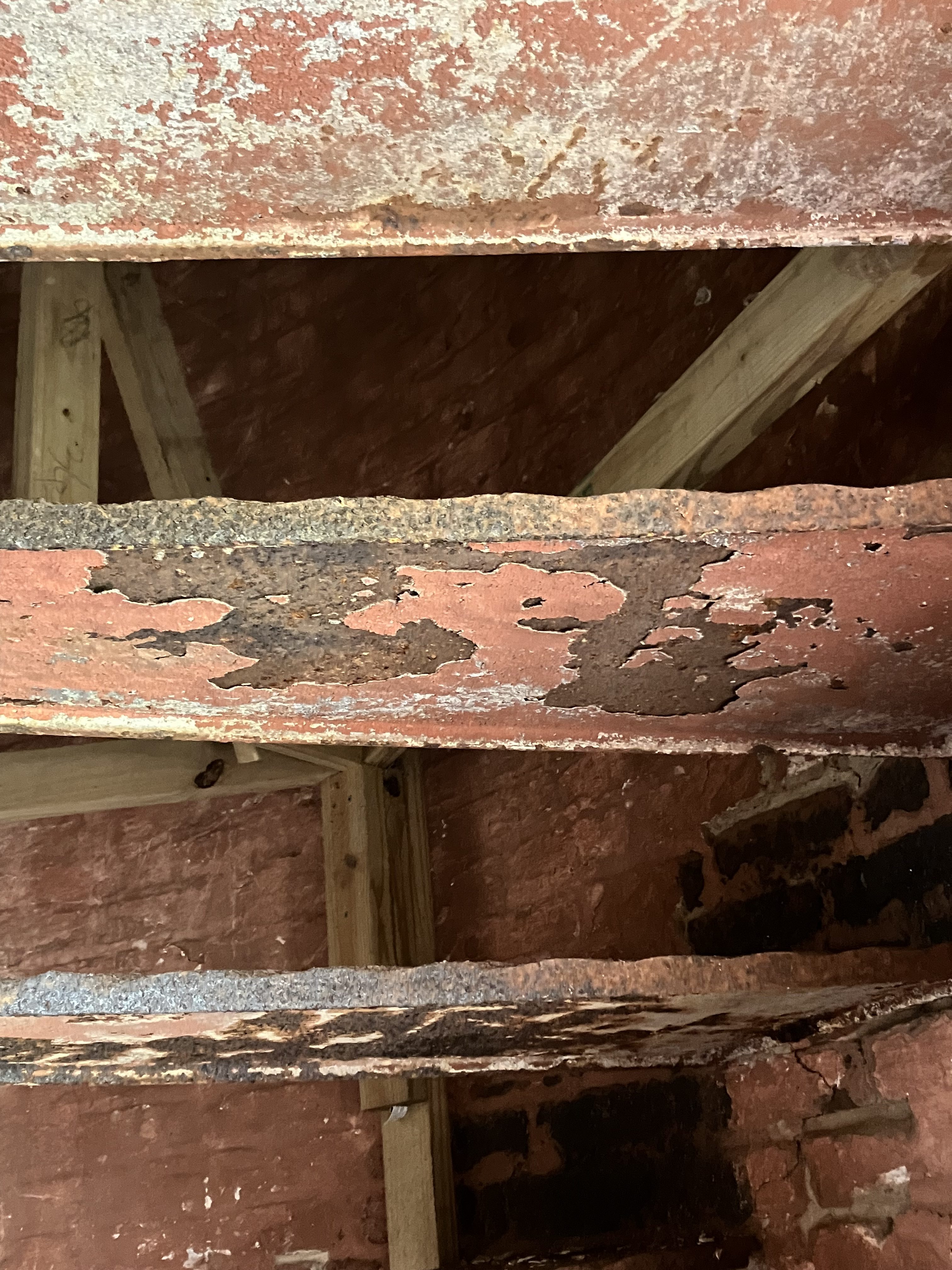 Peeling red paint on the iron stair treads
