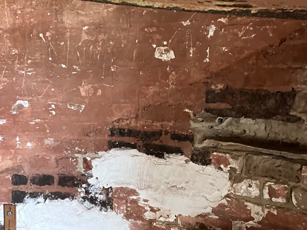 Crumbling plaster and old brick inside the lighthouse