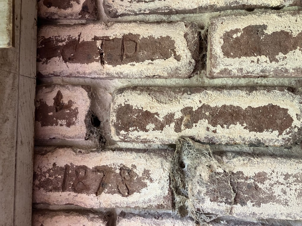 Date 1878 carved into the old bricks inside the lighthouse