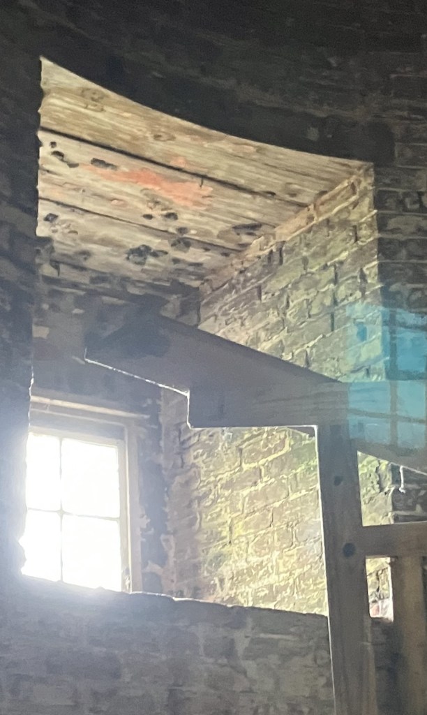 Light streaming through a window inside the lighthouse tower