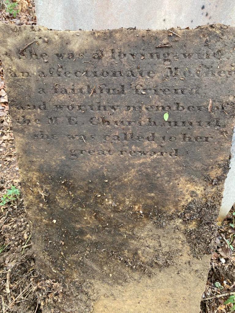 Weathered gravestone of Elizabeth Potter, inscribed She was a loving wife, an affectionate mother