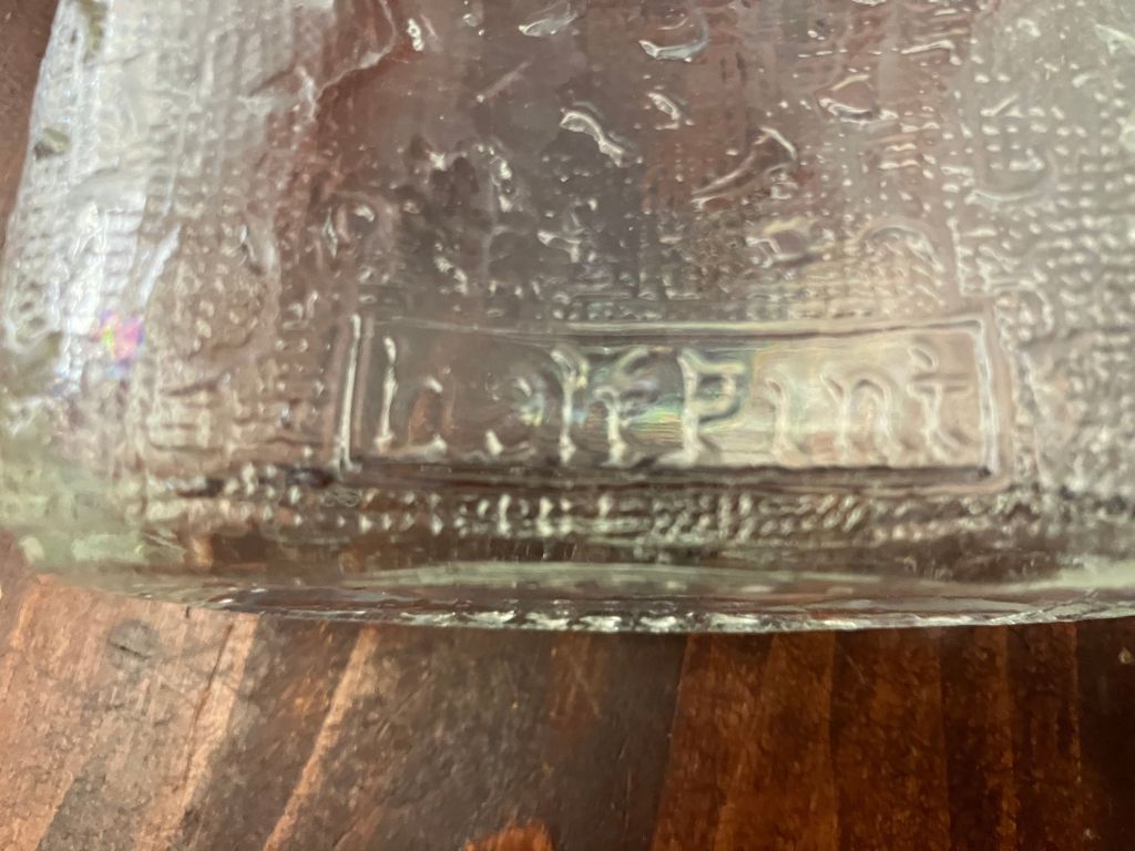Close view of embossed lettering on the glass flask