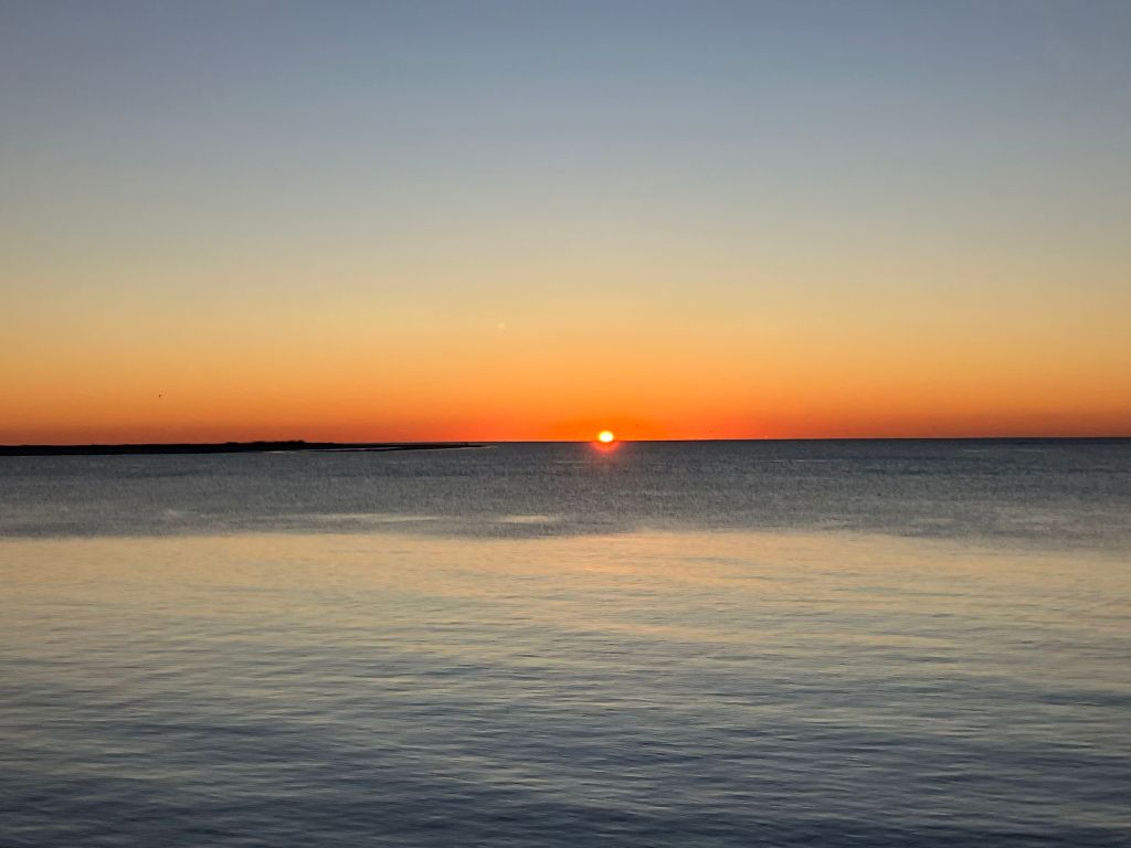 Sun rising over calm water at St. Phillips Island