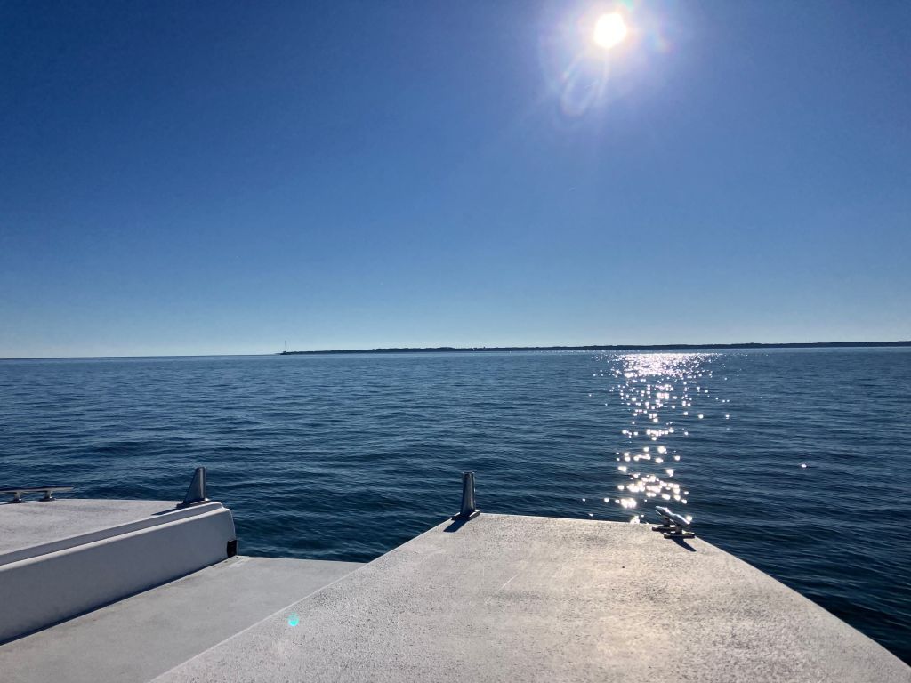 Sun shining over the water from the boat