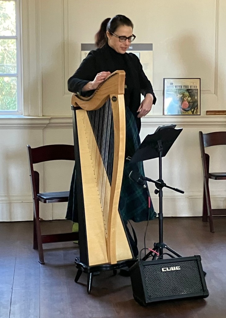 Harpist tuning her harp in the Long Room at Hampton Plantation