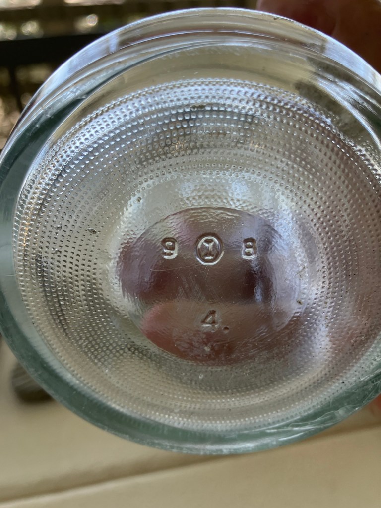 Base of the glass bottle with embossed maker's marks