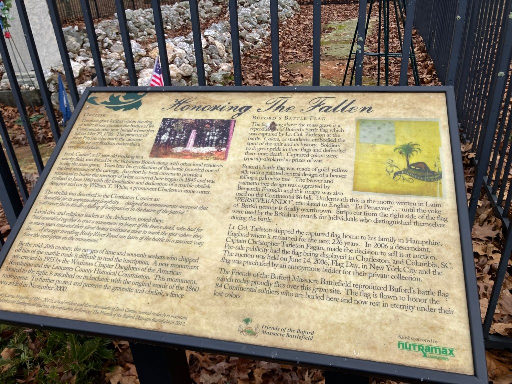 Interpretive panel titled Honoring the Fallen inside the fence at the Waxhaws battlefield