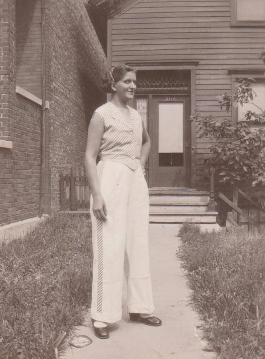 Camille Leonetti standing outside the family house in a light summer dress
