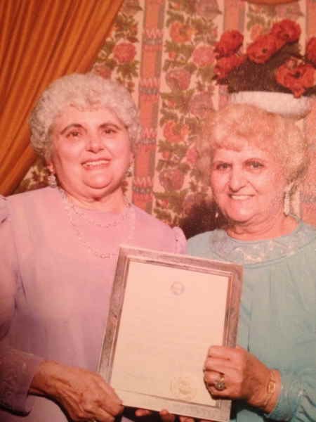 Camille and her sister Marie smiling together at a party